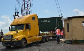 container being moved from a barge at the Port of Belize – Best Places In The World To Retire – International Living